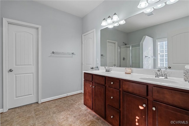 bathroom featuring a shower with door, tile patterned flooring, and vanity