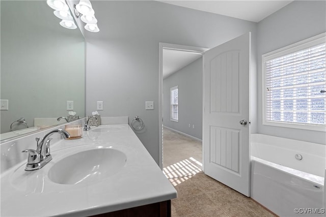 bathroom featuring tile patterned flooring, vanity, and a washtub