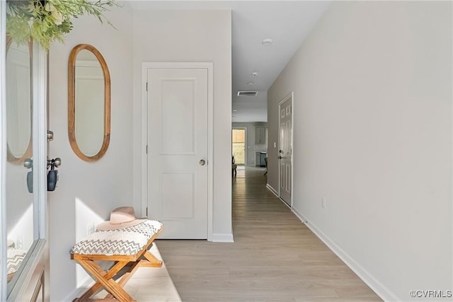 corridor with light hardwood / wood-style flooring