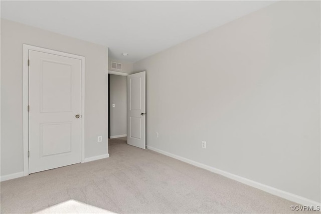 unfurnished bedroom featuring light carpet