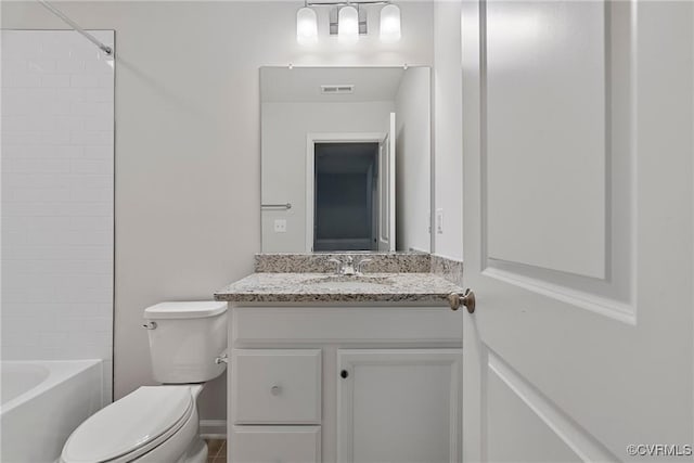 full bathroom with vanity, toilet, and tiled shower / bath