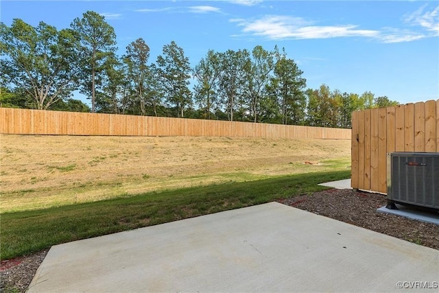 view of yard with cooling unit and a patio area