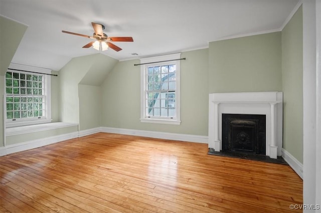 bonus room with baseboards, a healthy amount of sunlight, and hardwood / wood-style floors