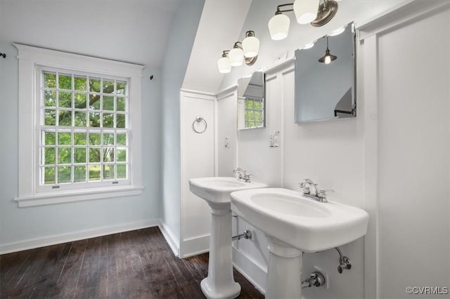 bathroom featuring a wealth of natural light, baseboards, and wood finished floors