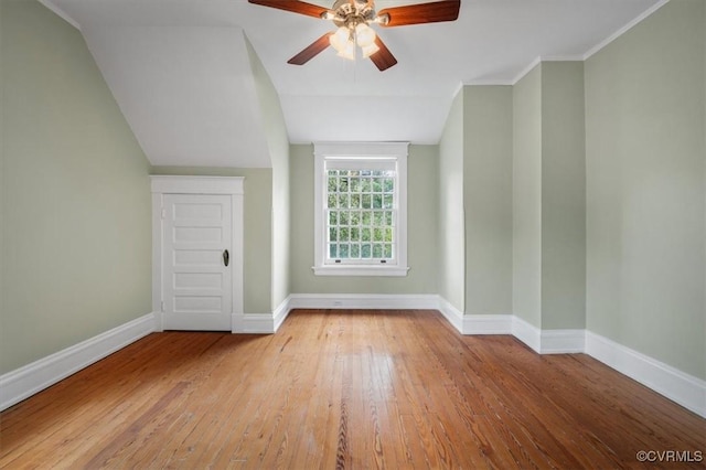 bonus room with a ceiling fan, lofted ceiling, hardwood / wood-style floors, and baseboards