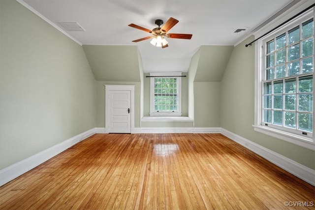 bonus room featuring lofted ceiling, baseboards, and hardwood / wood-style floors