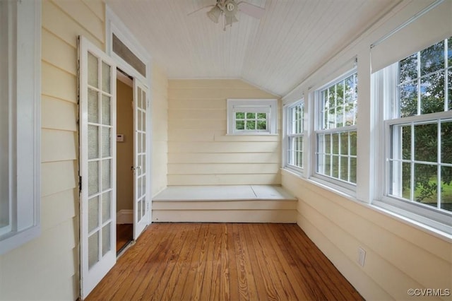 unfurnished sunroom featuring lofted ceiling, french doors, wood ceiling, and a wealth of natural light