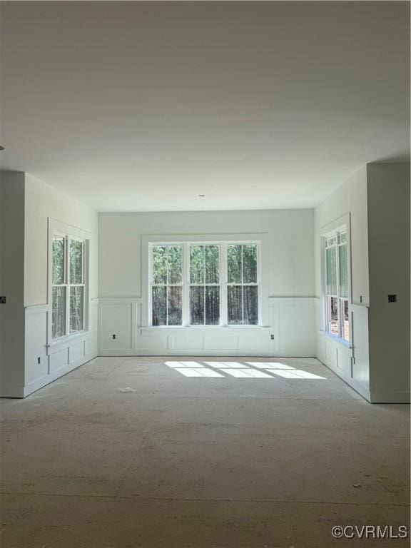 empty room with a wainscoted wall and a decorative wall