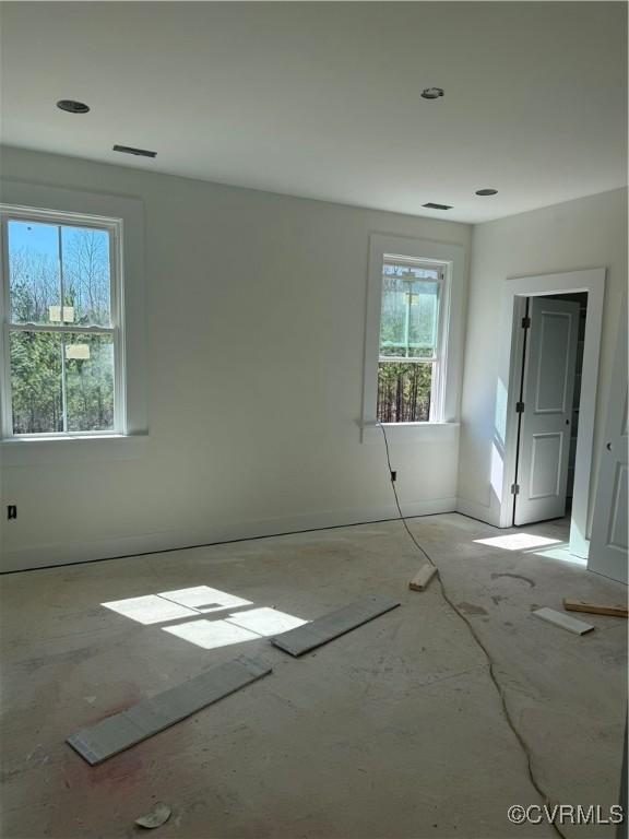 unfurnished room featuring baseboards