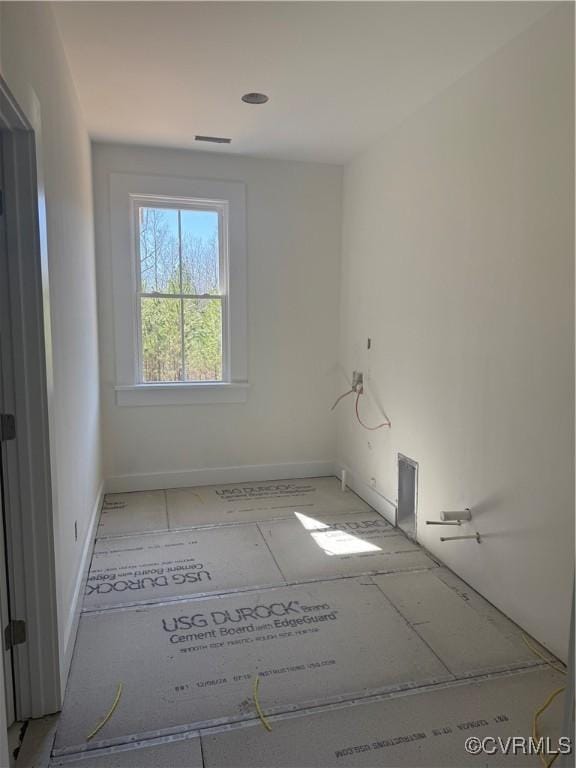 unfurnished room featuring baseboards