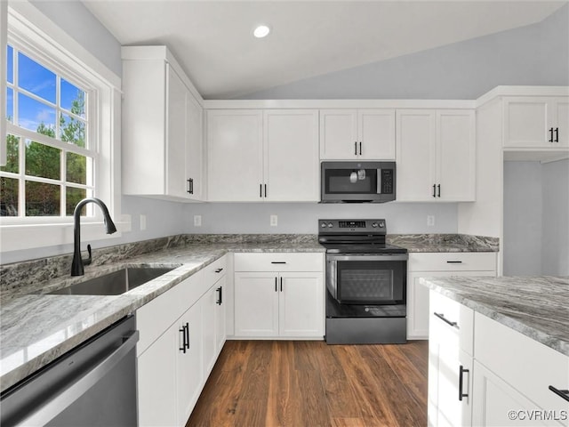 kitchen featuring light stone countertops, appliances with stainless steel finishes, dark hardwood / wood-style flooring, sink, and white cabinetry