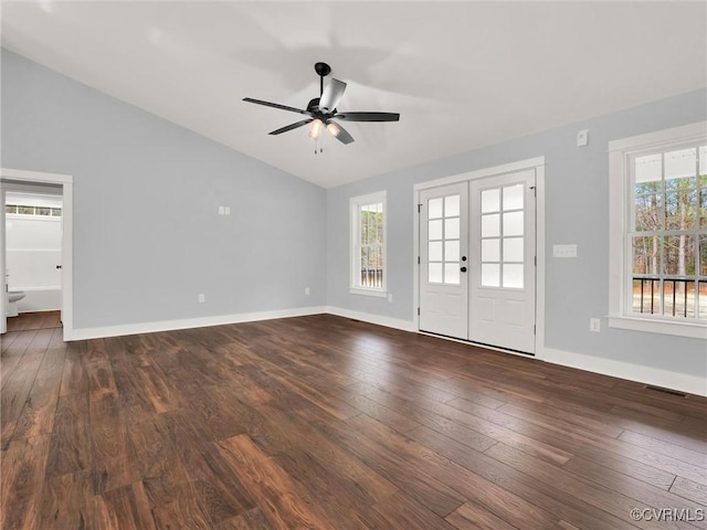 spare room featuring ceiling fan, a healthy amount of sunlight, lofted ceiling, and dark hardwood / wood-style floors