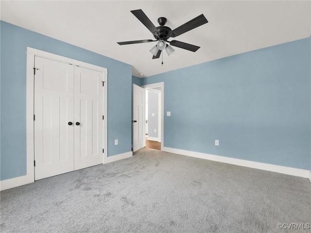 unfurnished bedroom with ceiling fan, a closet, and light colored carpet