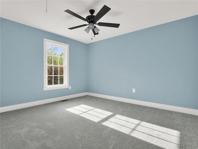 carpeted spare room featuring ceiling fan