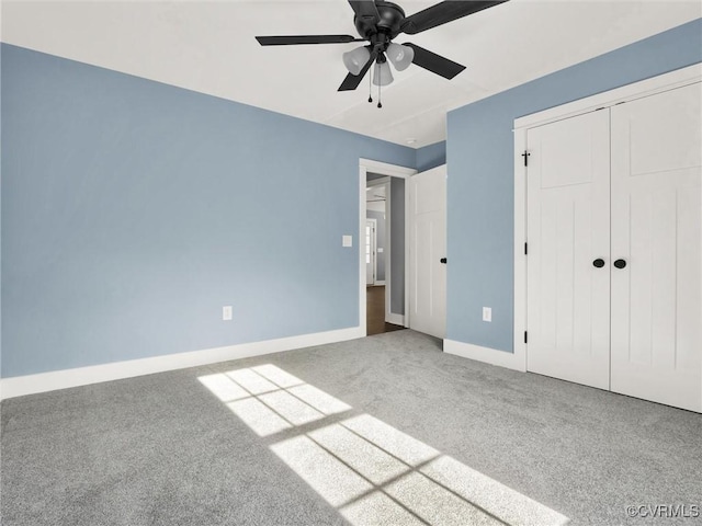 unfurnished bedroom with carpet flooring, ceiling fan, and a closet