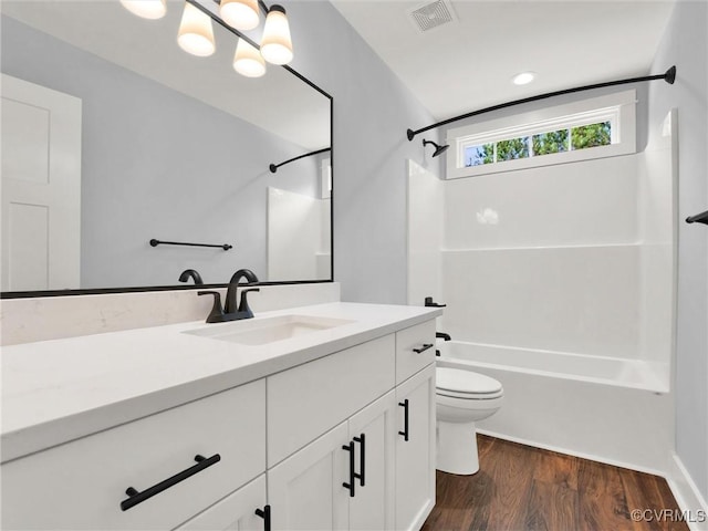 full bathroom with shower / tub combination, vanity, wood-type flooring, and toilet