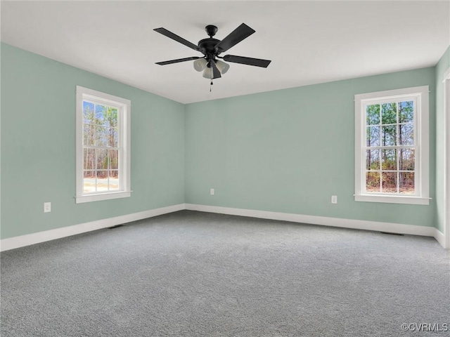 unfurnished room with carpet, plenty of natural light, and ceiling fan