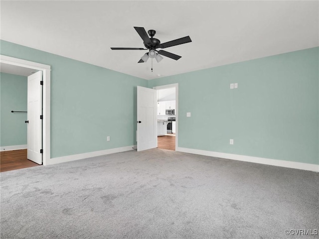 unfurnished bedroom featuring connected bathroom, ceiling fan, and light colored carpet