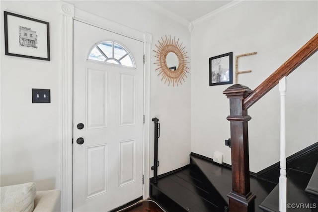 foyer entrance with hardwood / wood-style floors and ornamental molding