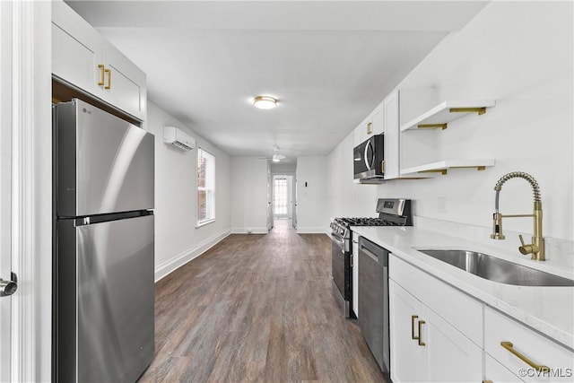 kitchen featuring a wall mounted air conditioner, white cabinets, sink, dark hardwood / wood-style flooring, and stainless steel appliances