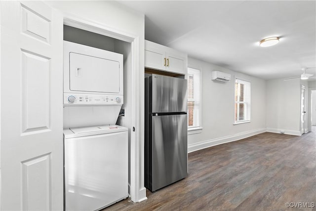 laundry room featuring a wall mounted AC, ceiling fan, dark hardwood / wood-style flooring, and stacked washer and clothes dryer