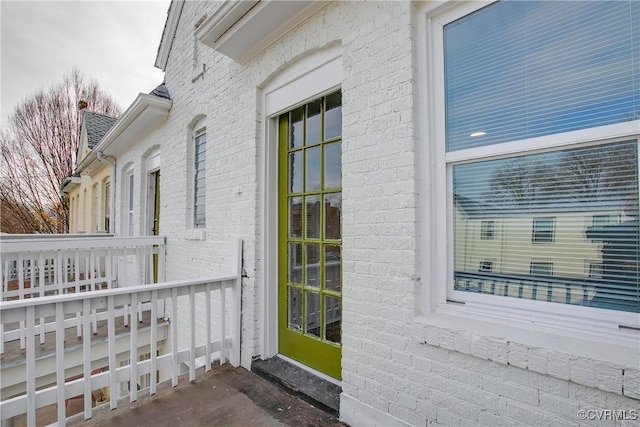 view of exterior entry featuring covered porch