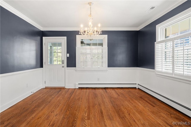 unfurnished dining area featuring crown molding, a baseboard heating unit, an inviting chandelier, and wood-type flooring