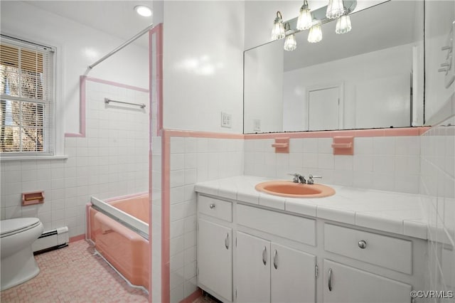 full bathroom with vanity, tile walls, tile patterned flooring, shower / tub combination, and baseboard heating