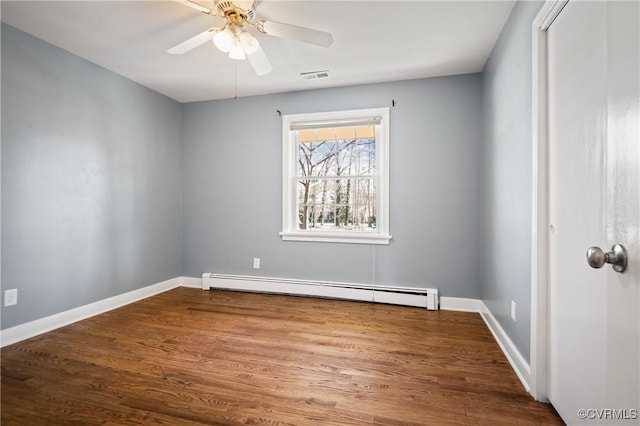 unfurnished room with ceiling fan, a baseboard heating unit, and hardwood / wood-style floors