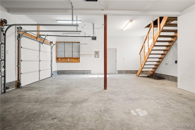 garage featuring a garage door opener and electric panel