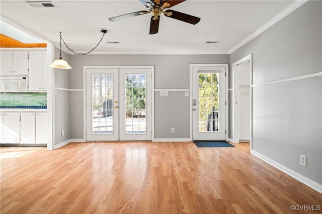 entryway featuring light hardwood / wood-style floors, ceiling fan, crown molding, and french doors