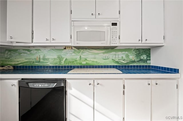 kitchen with decorative backsplash, white cabinets, and dishwasher