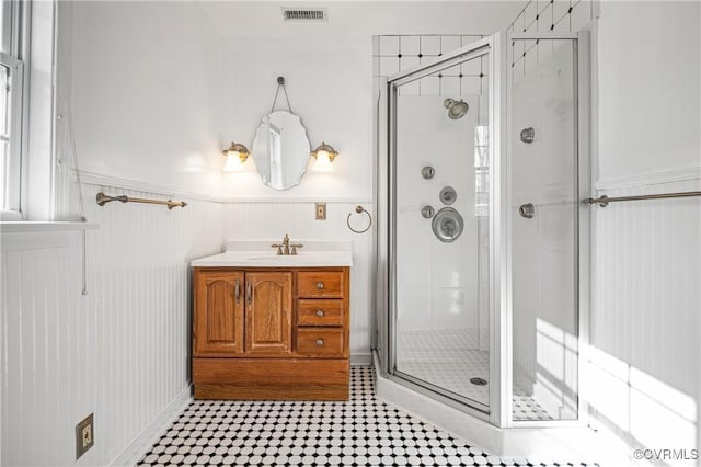 bathroom featuring walk in shower and vanity