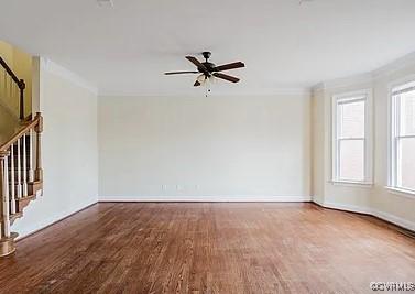 spare room with dark hardwood / wood-style floors, ceiling fan, and ornamental molding