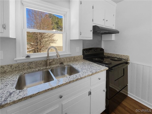 kitchen featuring light stone counters, black electric range oven, dark wood-type flooring, sink, and white cabinetry