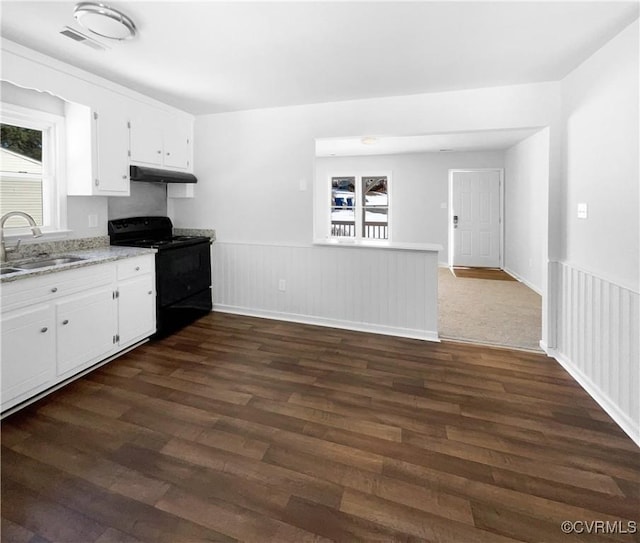 kitchen featuring white cabinets, black range with electric stovetop, dark wood-type flooring, and sink