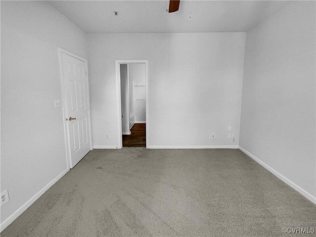 unfurnished room with ceiling fan and carpet