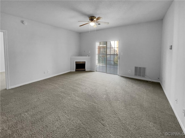 unfurnished living room with carpet and ceiling fan