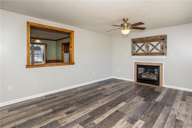 unfurnished living room with ceiling fan, dark hardwood / wood-style flooring, and a tile fireplace