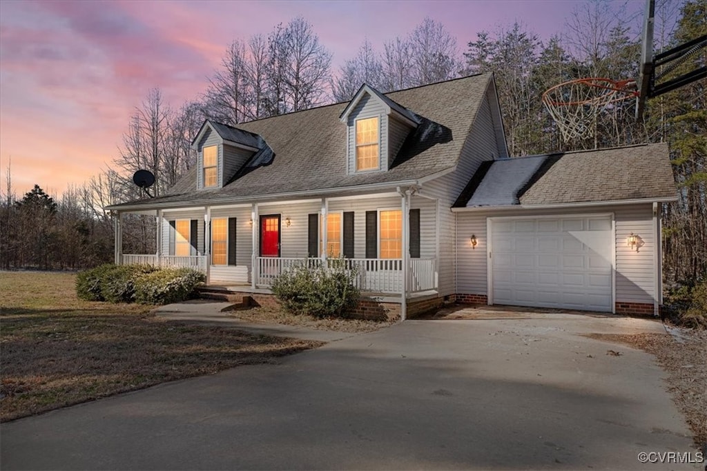 new england style home with a porch and a garage