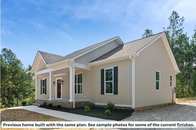 view of front of home with covered porch and roof with shingles