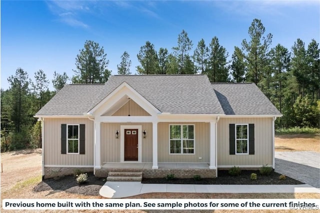 view of front of property featuring a porch and roof with shingles