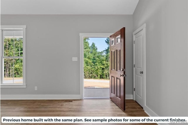 entrance foyer featuring wood finished floors and baseboards