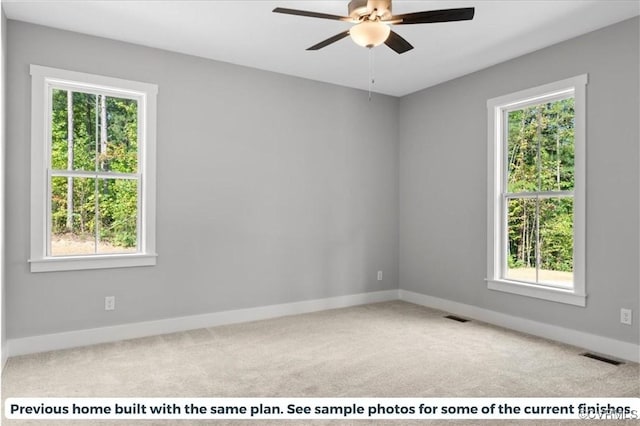 carpeted empty room with plenty of natural light, visible vents, and baseboards