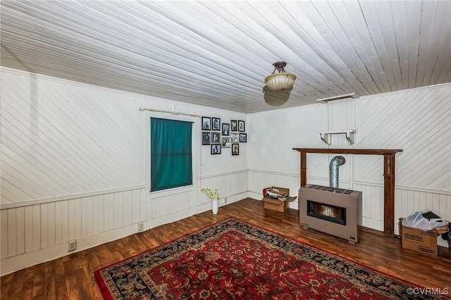 interior space featuring wood-type flooring, heating unit, and wood ceiling