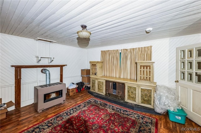 interior space with heating unit, dark wood-type flooring, and wood ceiling