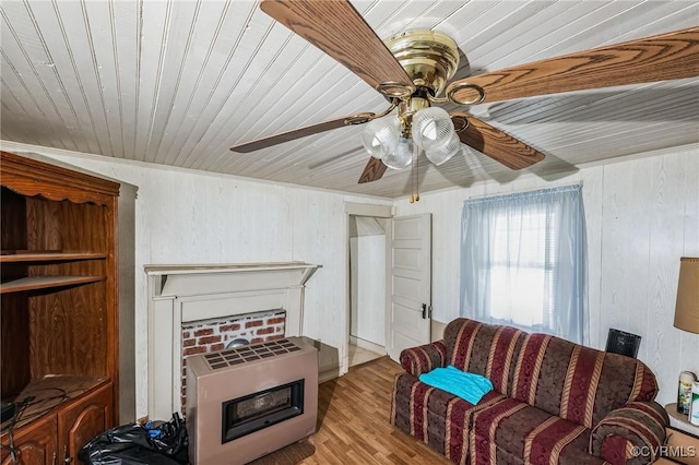 living room with heating unit and light hardwood / wood-style flooring