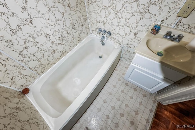 bathroom with vanity and a tub