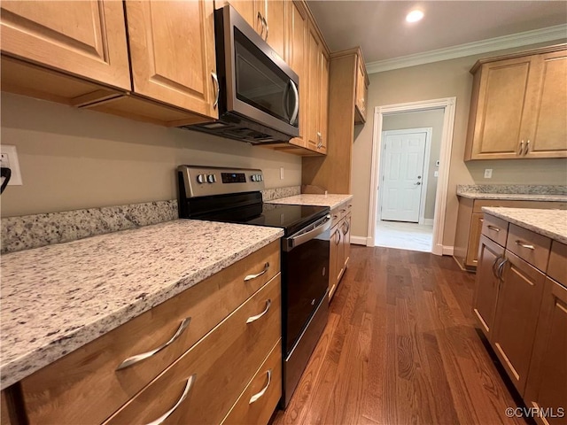 kitchen with crown molding, stainless steel appliances, dark wood-type flooring, and light stone counters