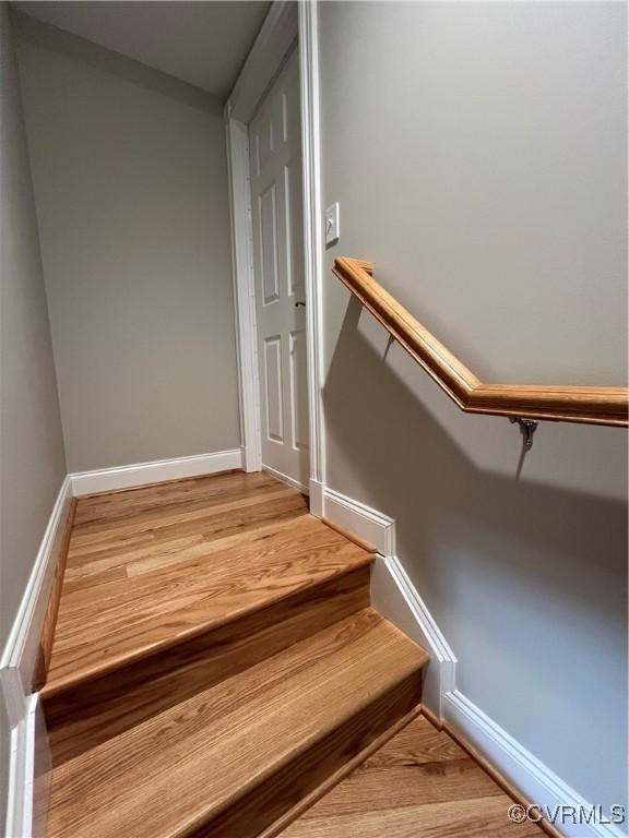 stairs featuring hardwood / wood-style flooring